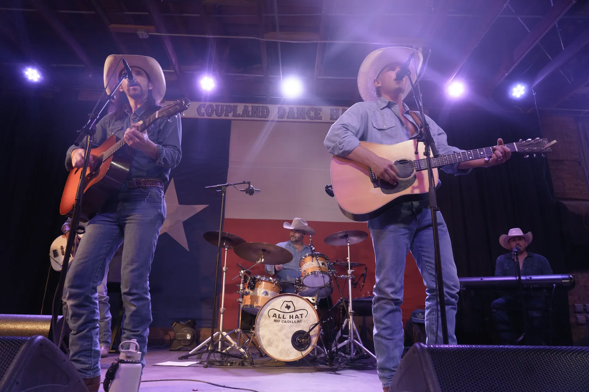 All Hat No Cadillac performing in front of the Texas flag, available for events in Dallas TX