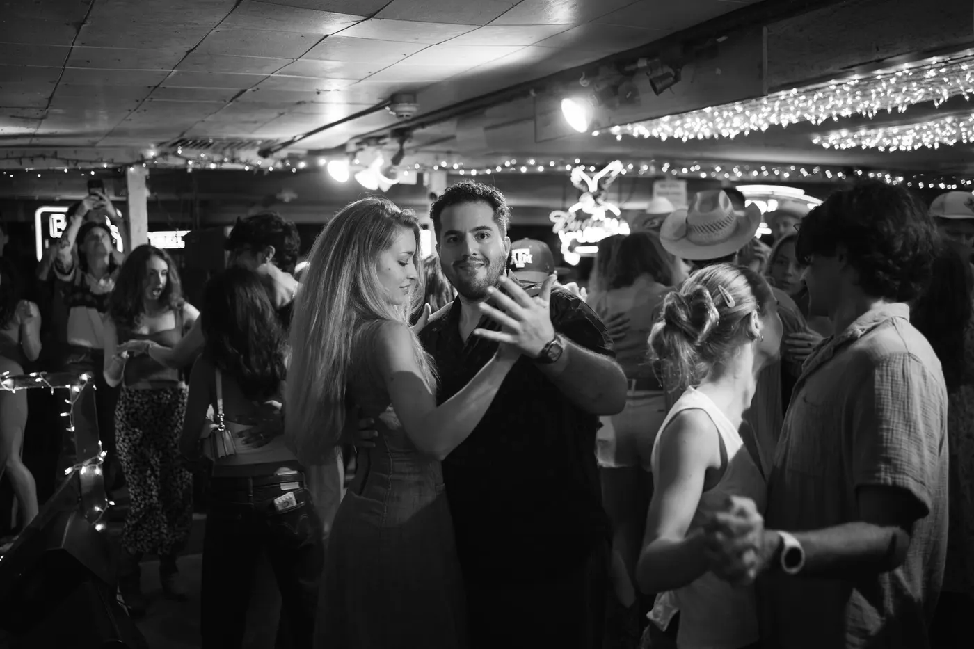 Couple slow dancing to All Hat No Cadillac — black and white
