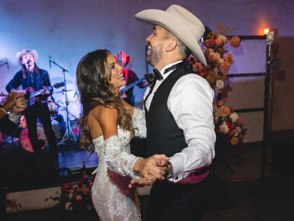 country wedding - a bride and groom listening to all hat no cadillac live at their wedding reception